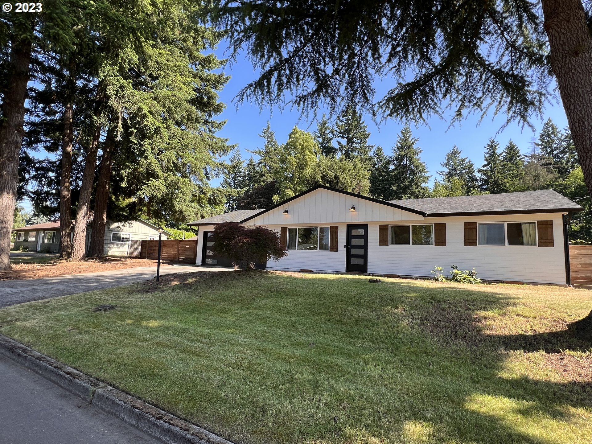 a house that has a big yard and large trees