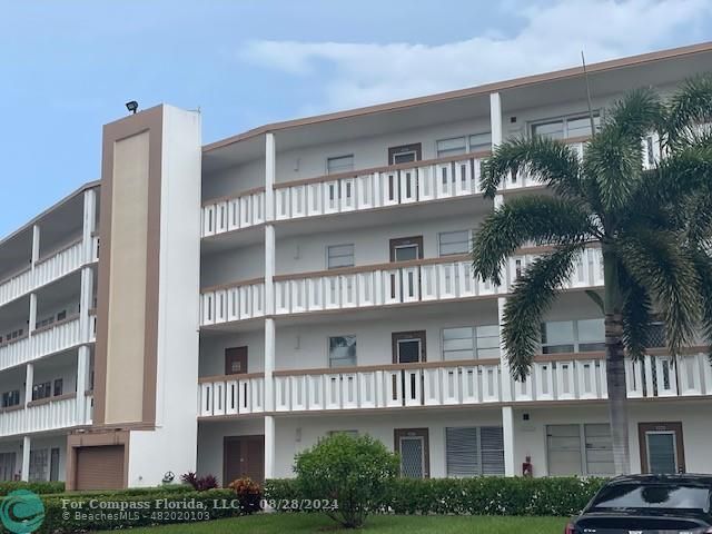 a front view of a residential apartment building with a yard