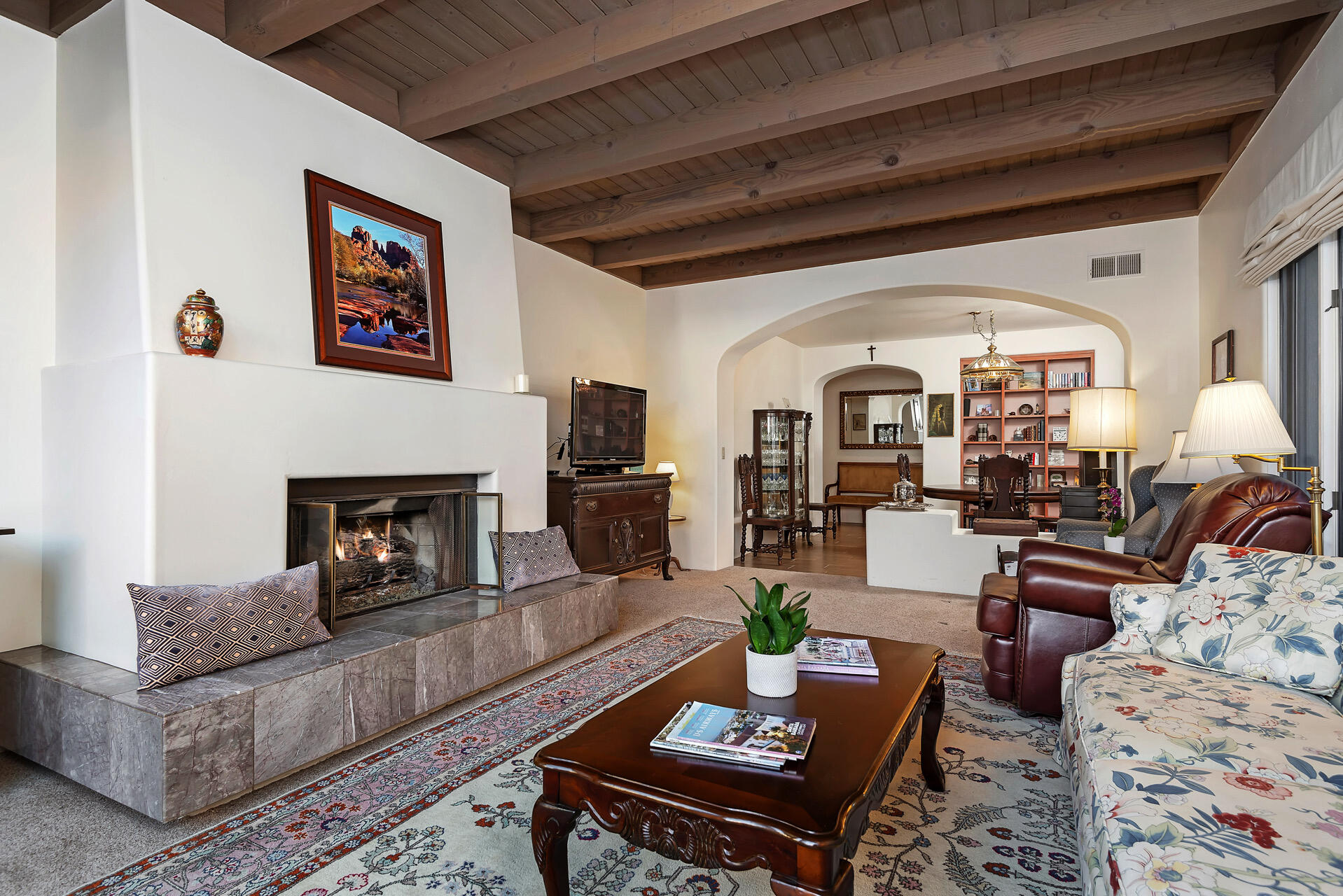 a living room with furniture and a fireplace