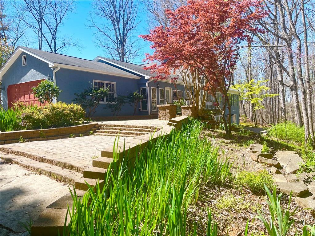 a view of a house with a yard and tree s