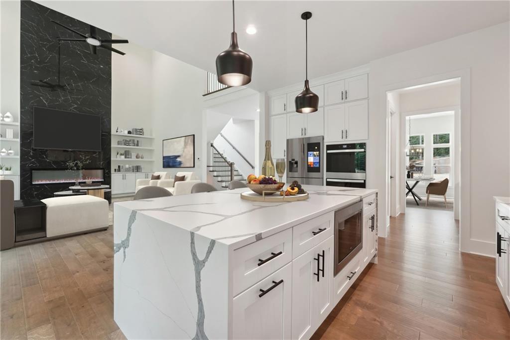 a kitchen with kitchen island a sink and a stove with wooden floor