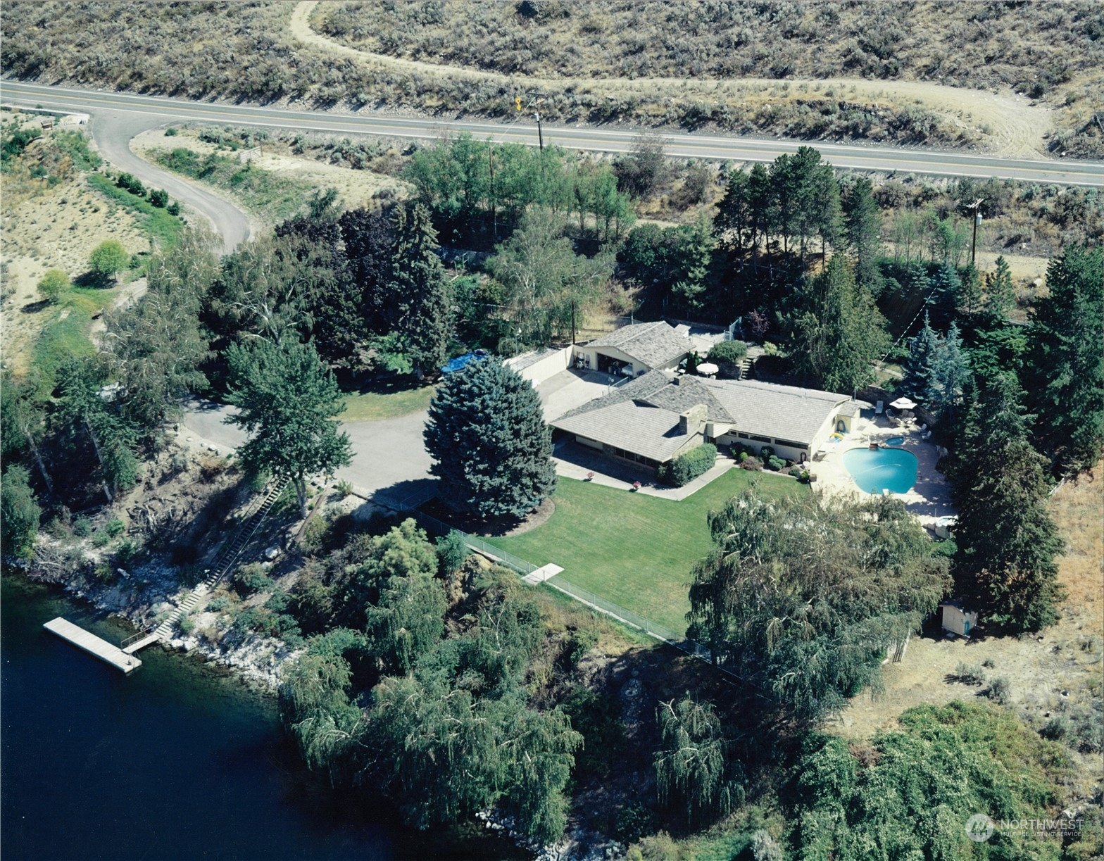 an aerial view of a house with yard