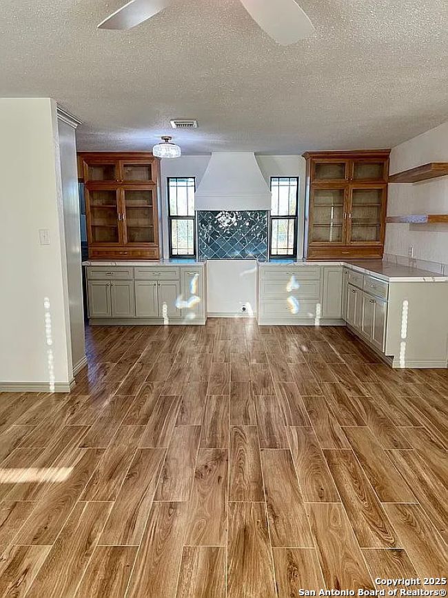 a view of a kitchen with a sink and a window