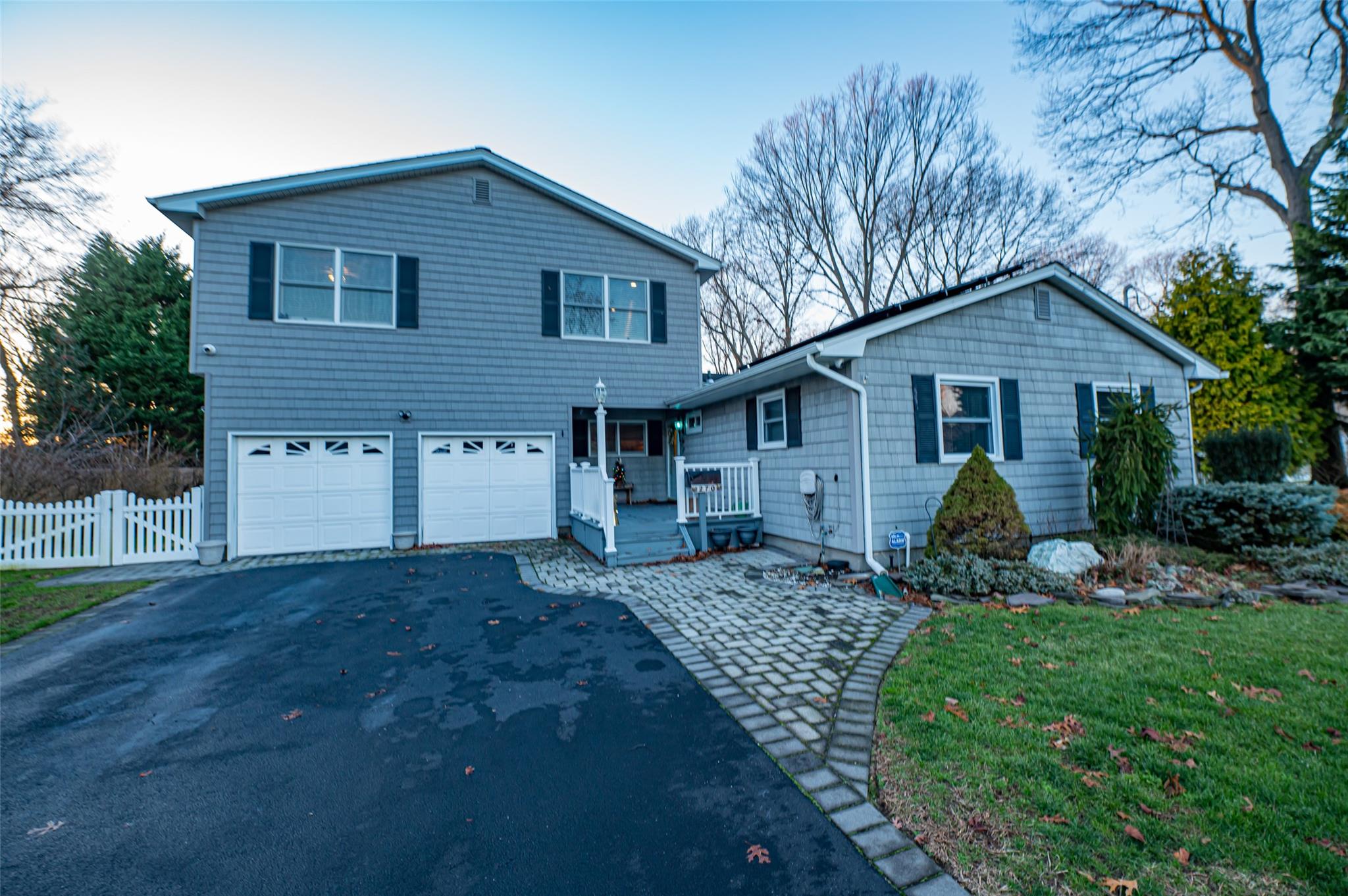 View of front of property with a front lawn and a garage