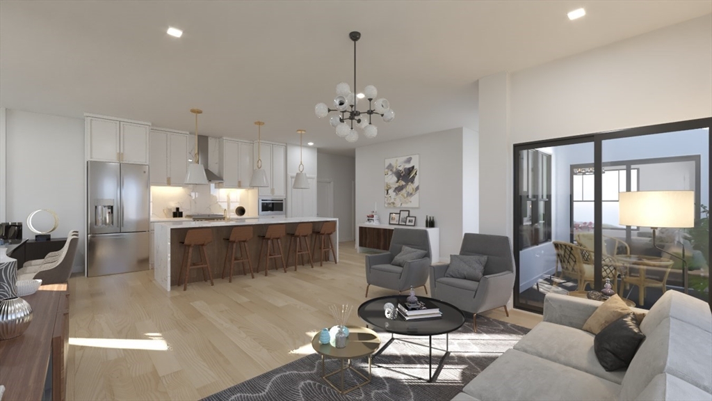 a living room with furniture kitchen view and a chandelier