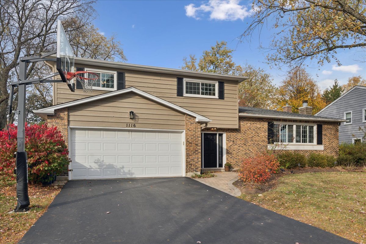 a view of a house with a yard and garage