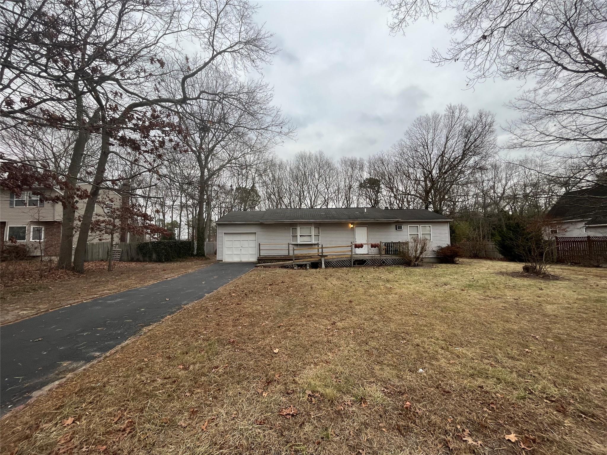 View of front of property featuring a front lawn and a garage