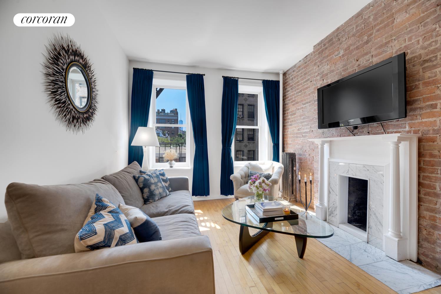 a living room with furniture fireplace and flat screen tv