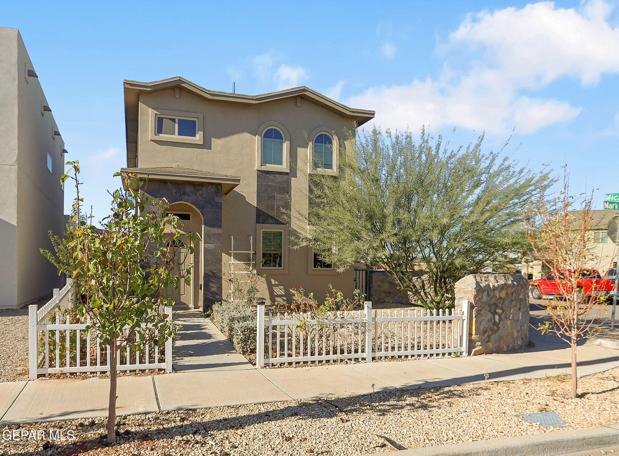 a front view of a house with a fence