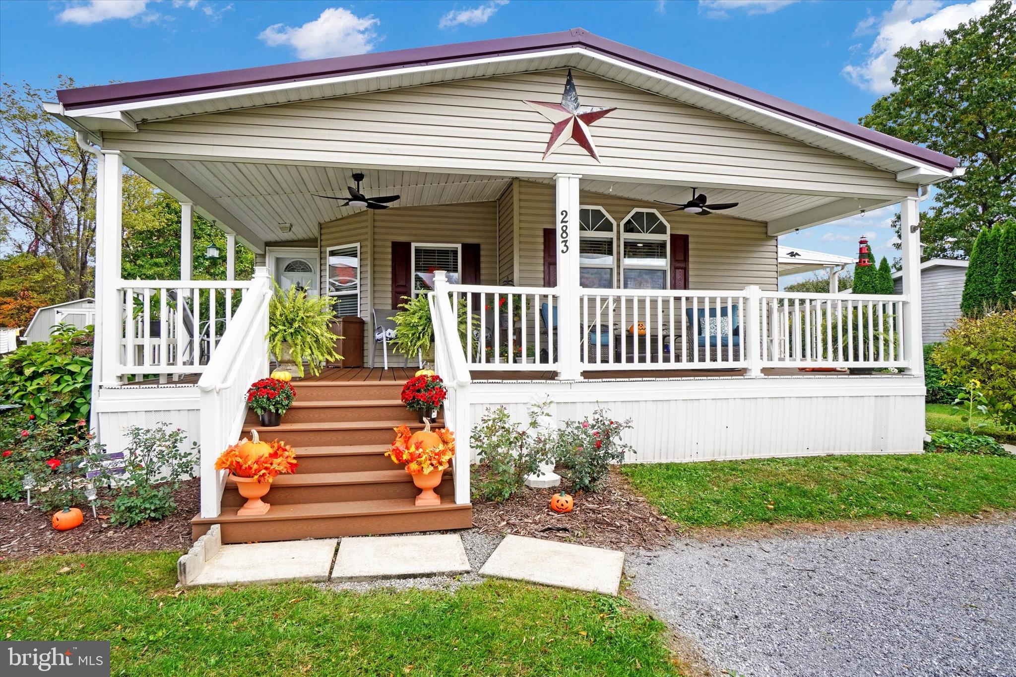 a front view of a house with a garden and deck