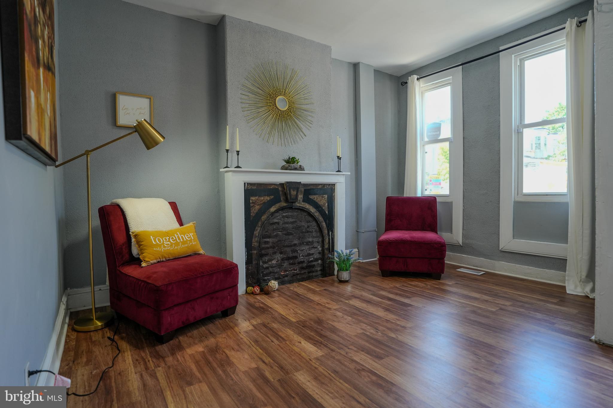 a living room with furniture and a fireplace