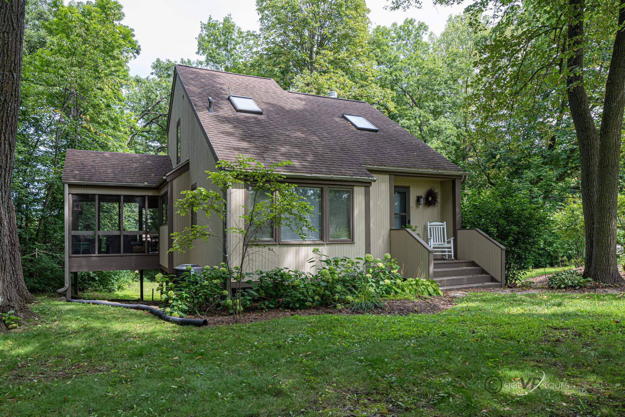 a view of a house with a yard and plants