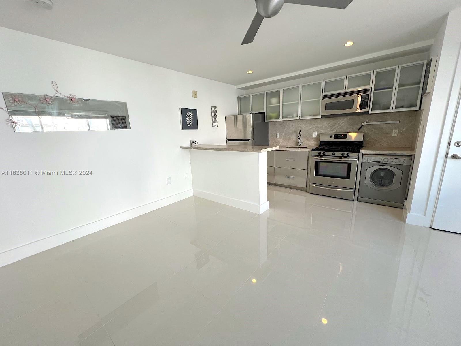 a kitchen with stainless steel appliances a refrigerator and a stove top oven