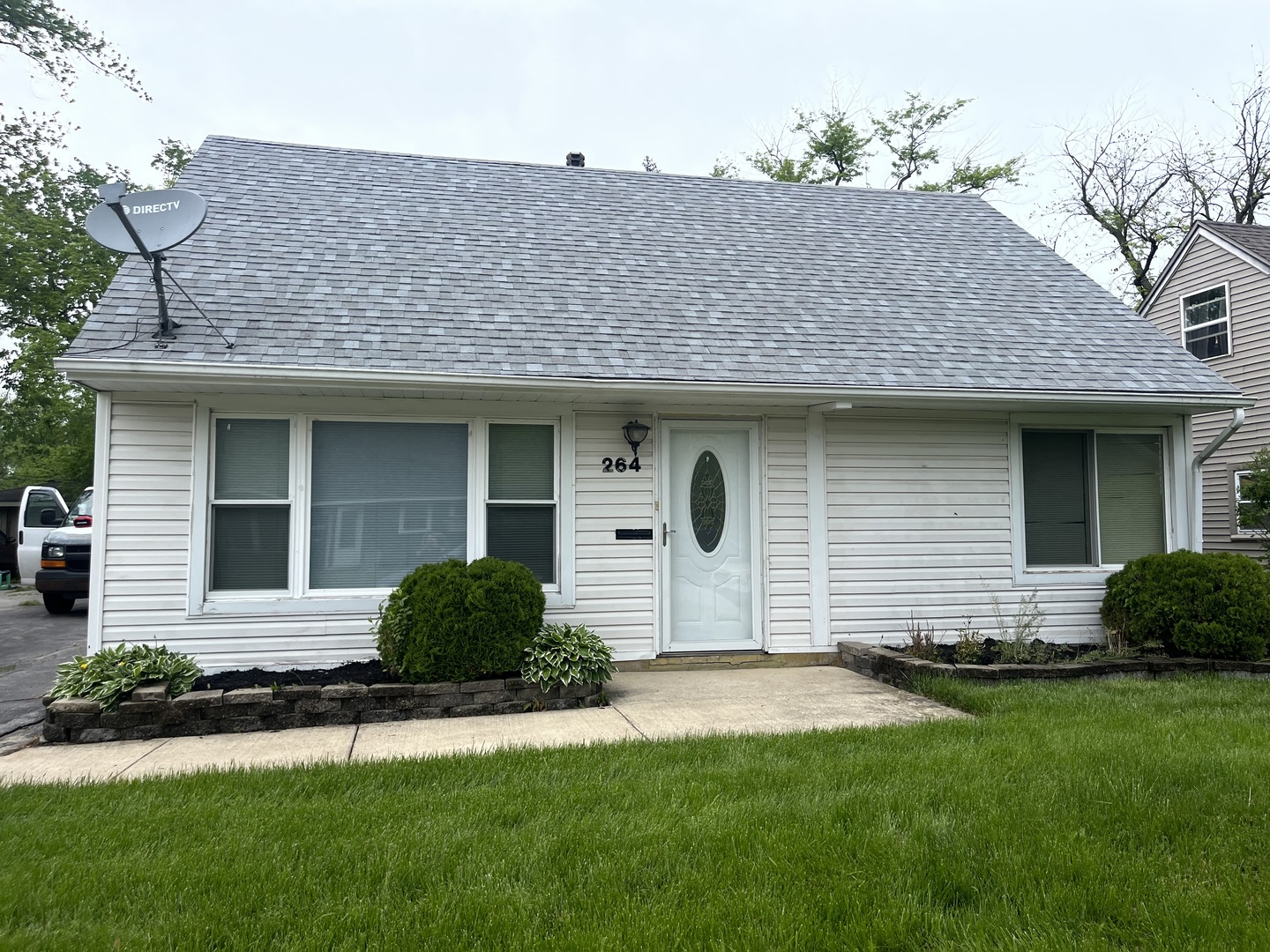 a front view of a house with a garden