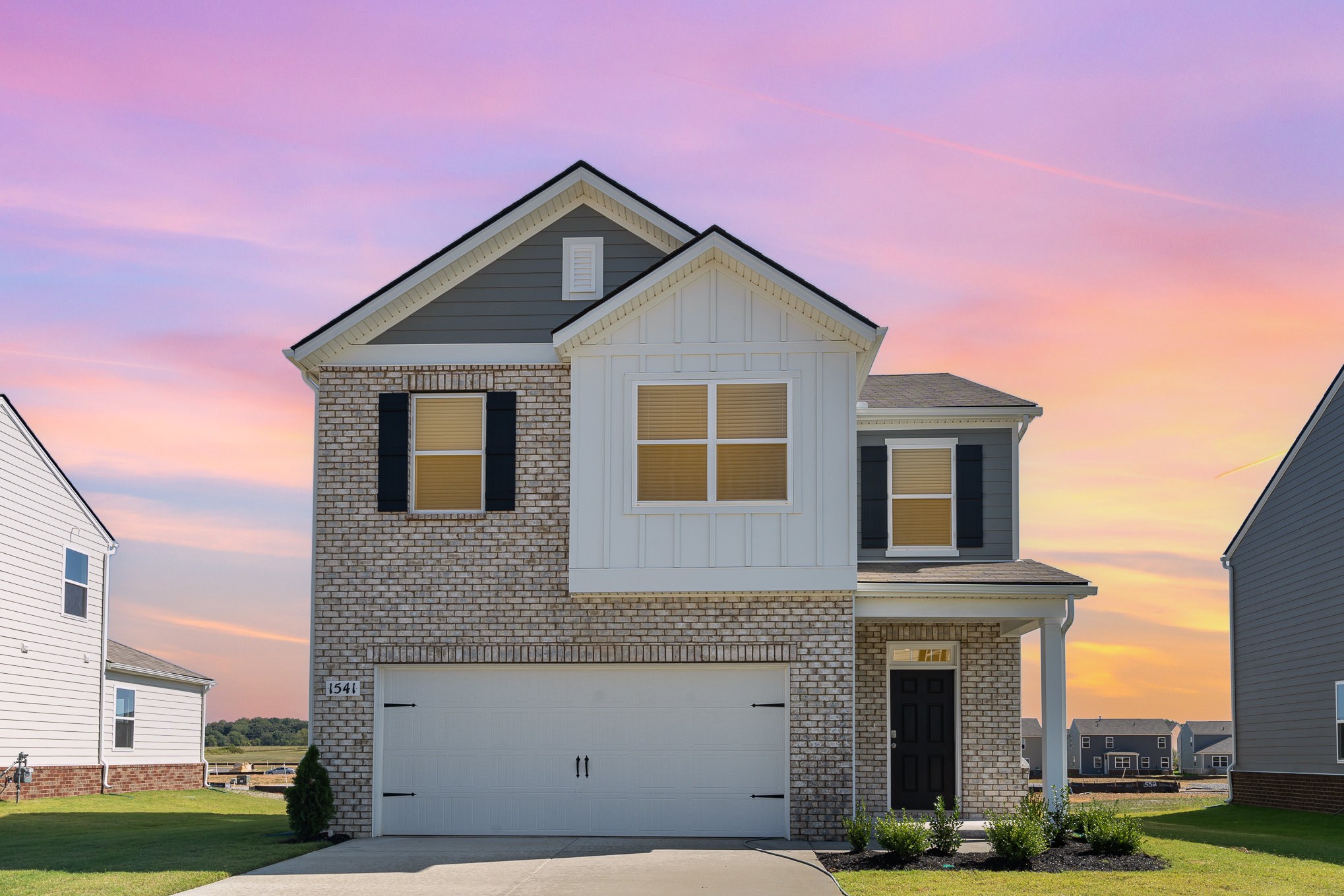 a front view of a house with garage