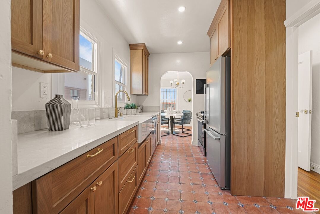 a kitchen with stainless steel appliances a sink and cabinets