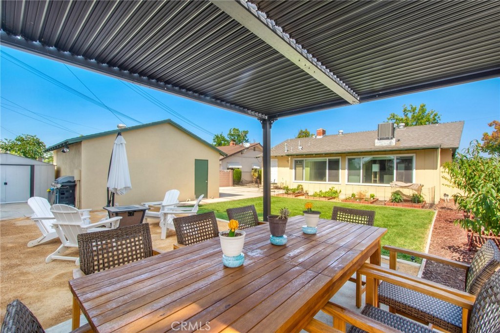 a view of a patio with table and chairs wooden floor and fence