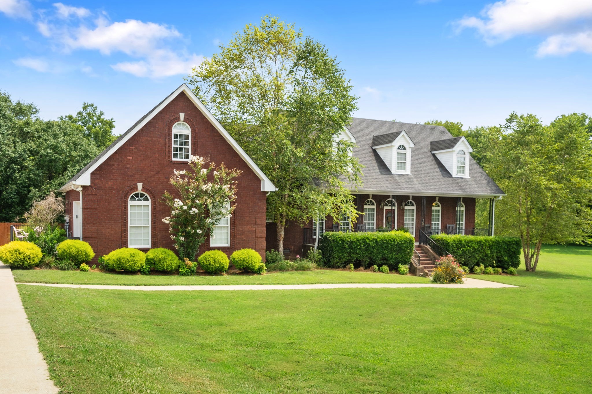 a front view of house with yard and green space