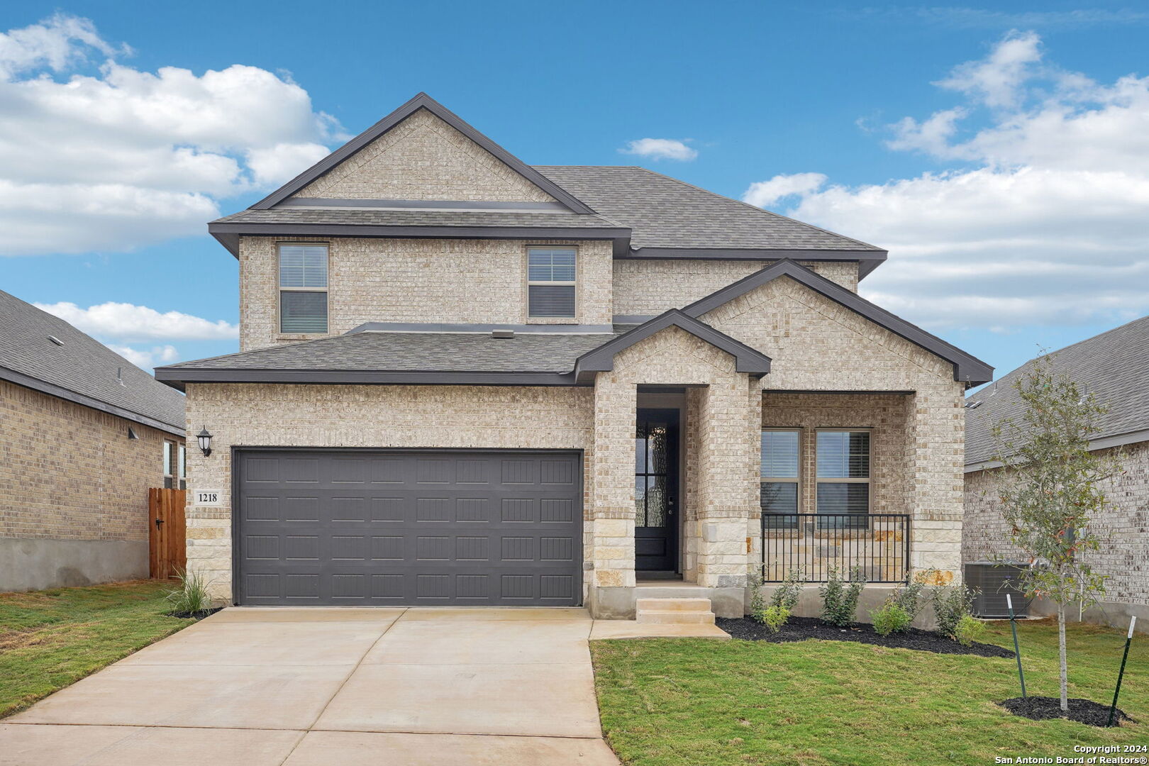 a front view of a house with a yard and garage