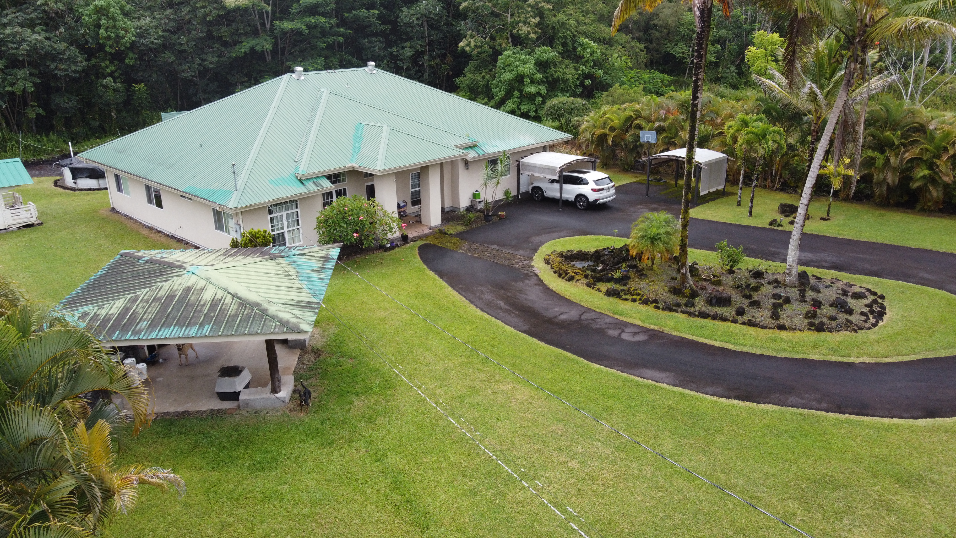 an aerial view of a house with garden space and street view