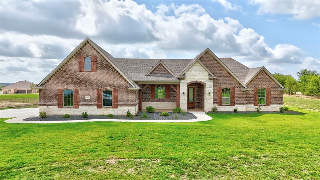 a front view of house with yard outdoor seating and barbeque oven