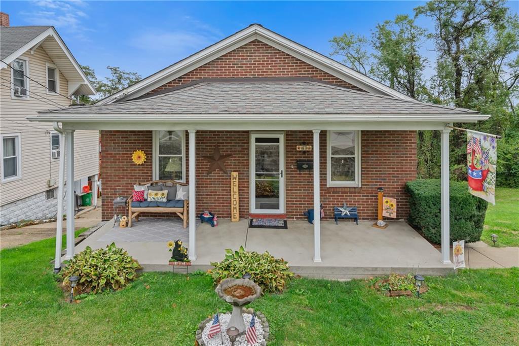 a front view of a house with a yard and porch