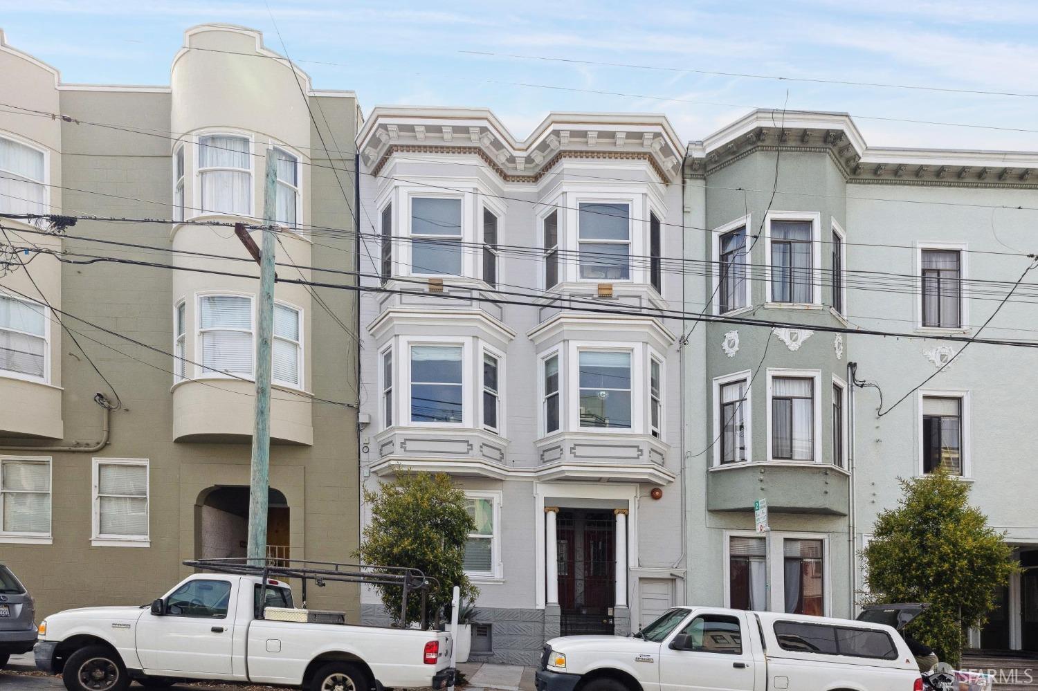 a front view of a residential apartment building with a yard