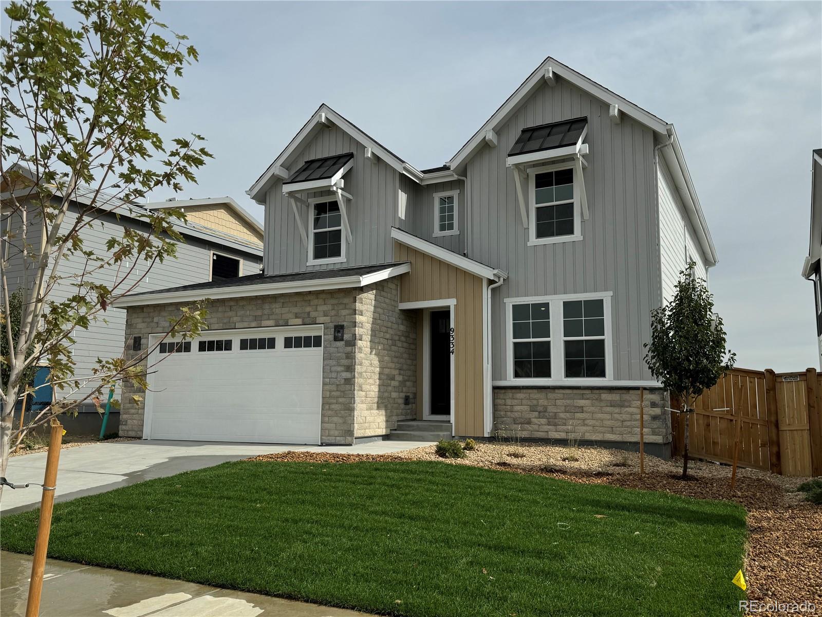 a front view of a house with a yard and garage