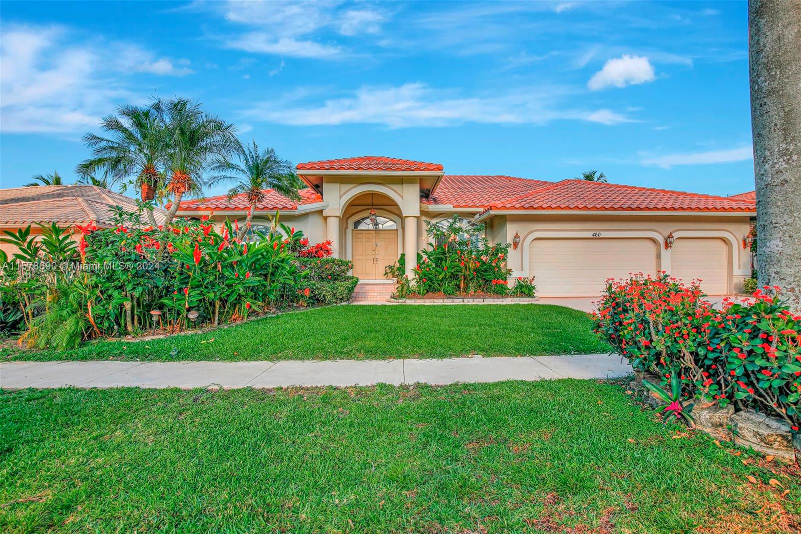 a front view of a house with a garden