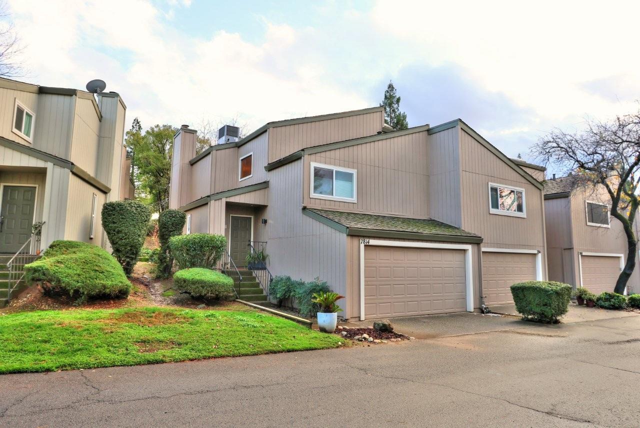 a front view of a house with a yard and garage