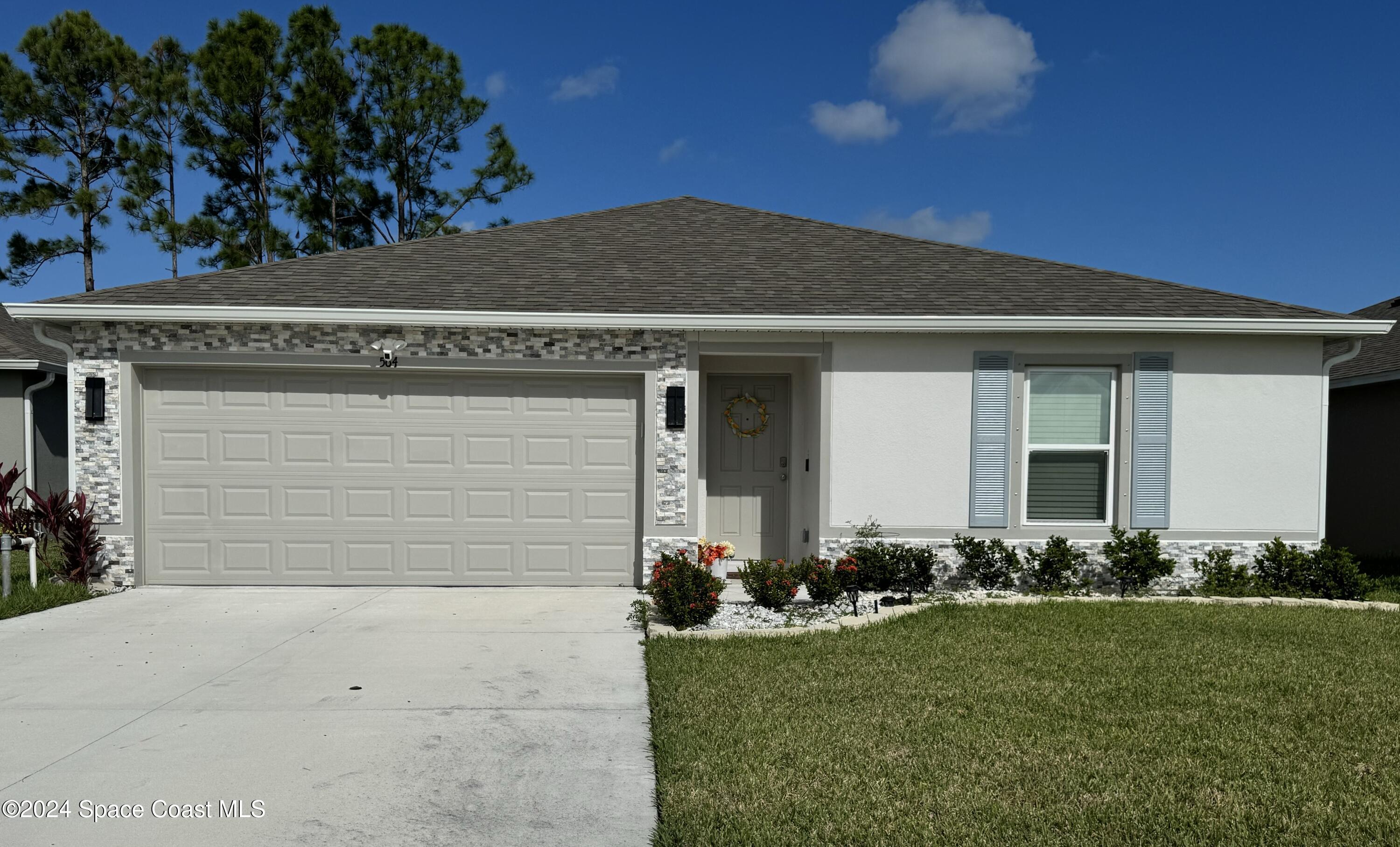 front view of a house with a yard