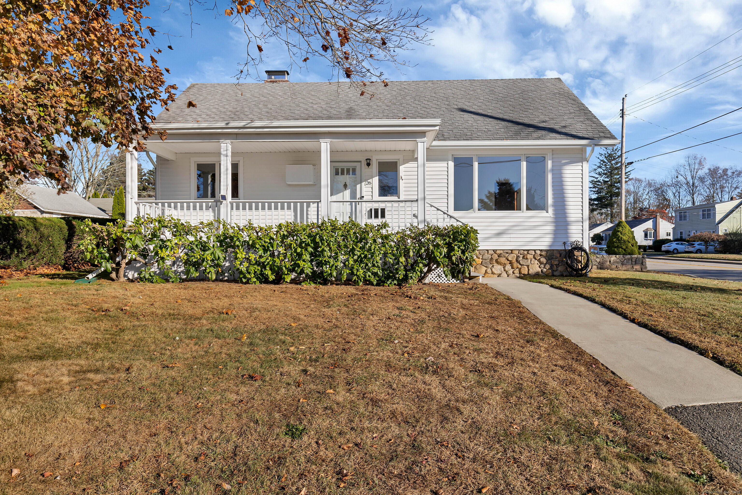 front view of a house with a bench