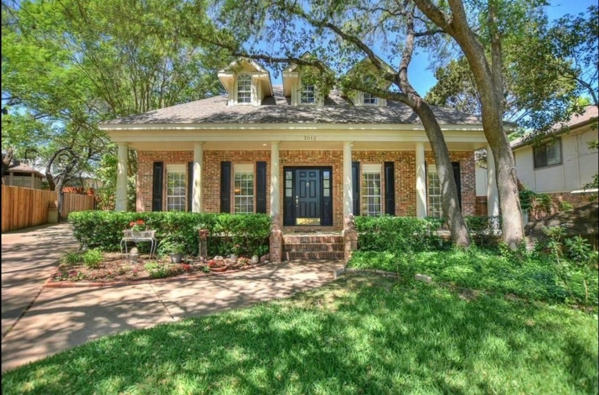 a view of a house with garden and plants