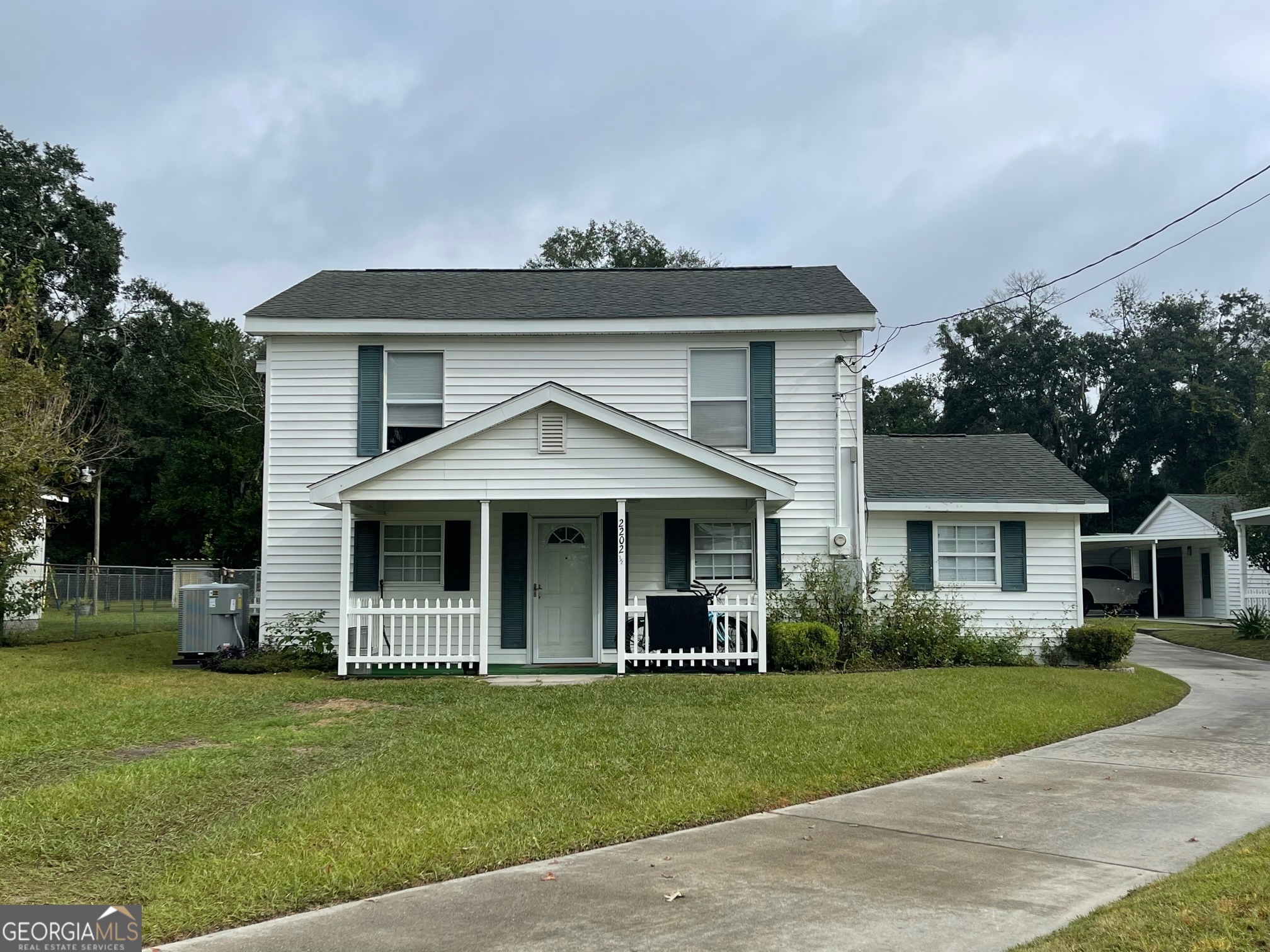 a front view of a house with a garden