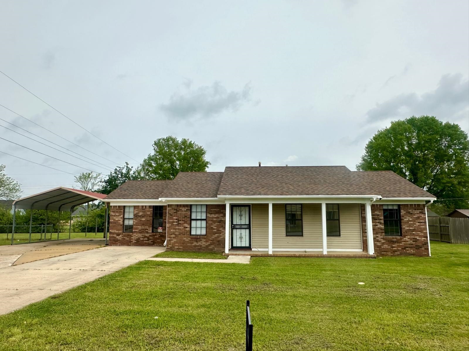 a front view of a house with a garden