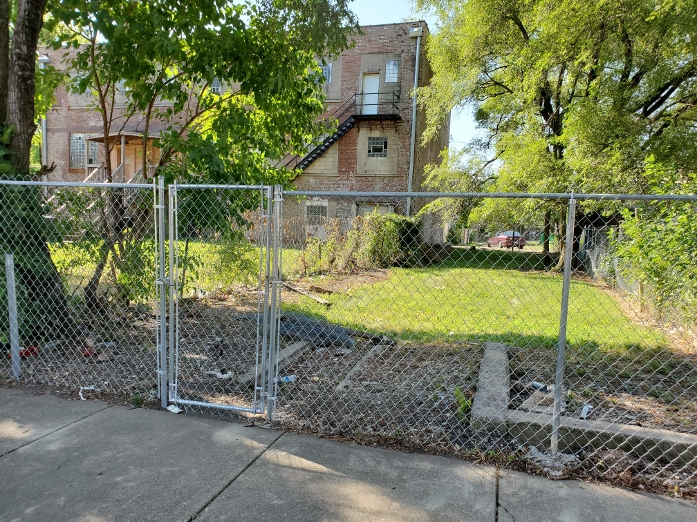 a view of a house with a backyard and a tree