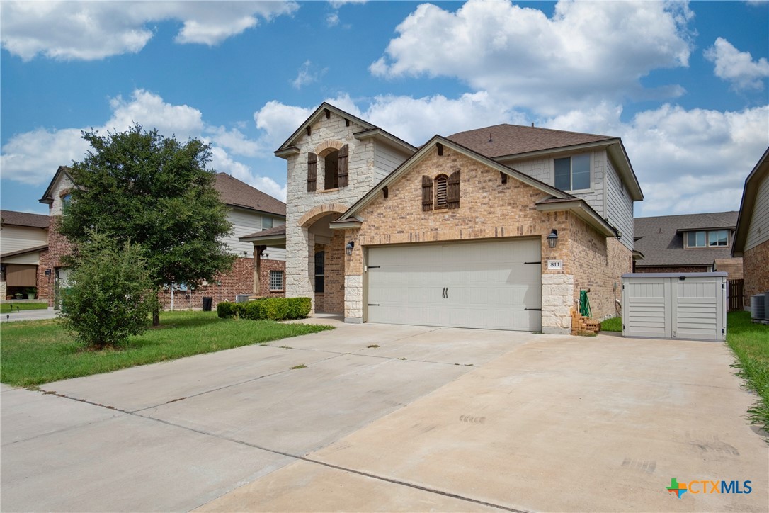 a front view of a house with a yard and garage