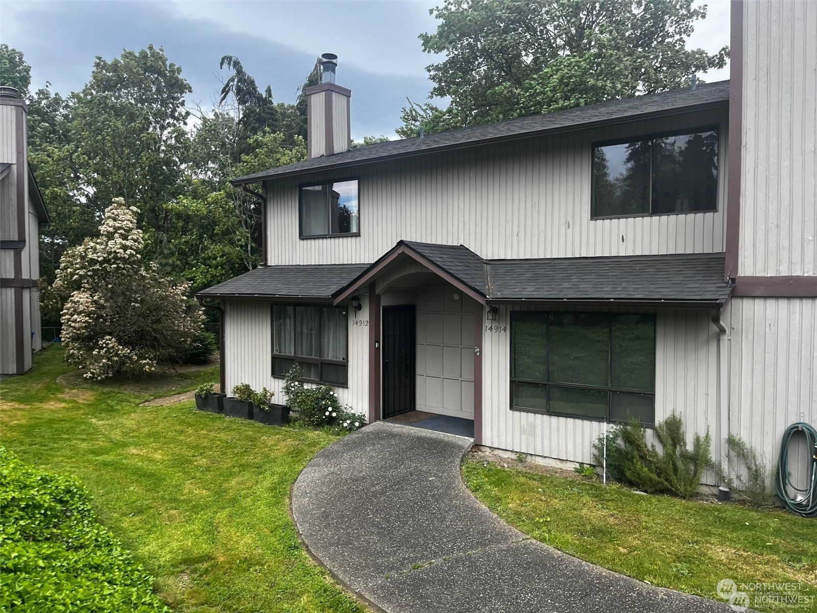 a front view of a house with garden