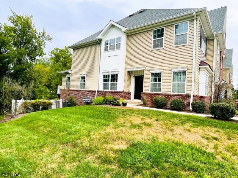 a view of a house with backyard and a garden