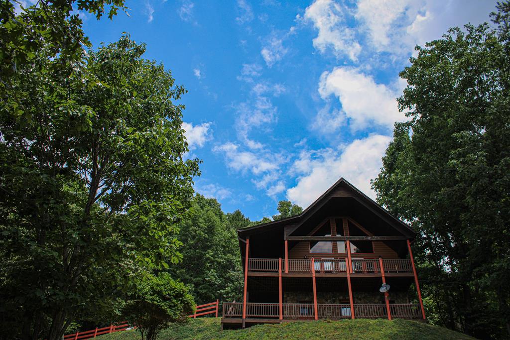 a front view of a house with a tree