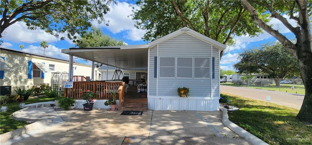 a view of a house with backyard and sitting area