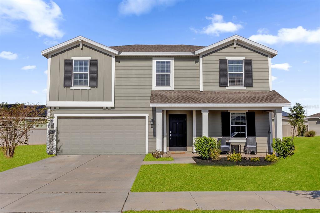 a front view of a house with a yard and garage