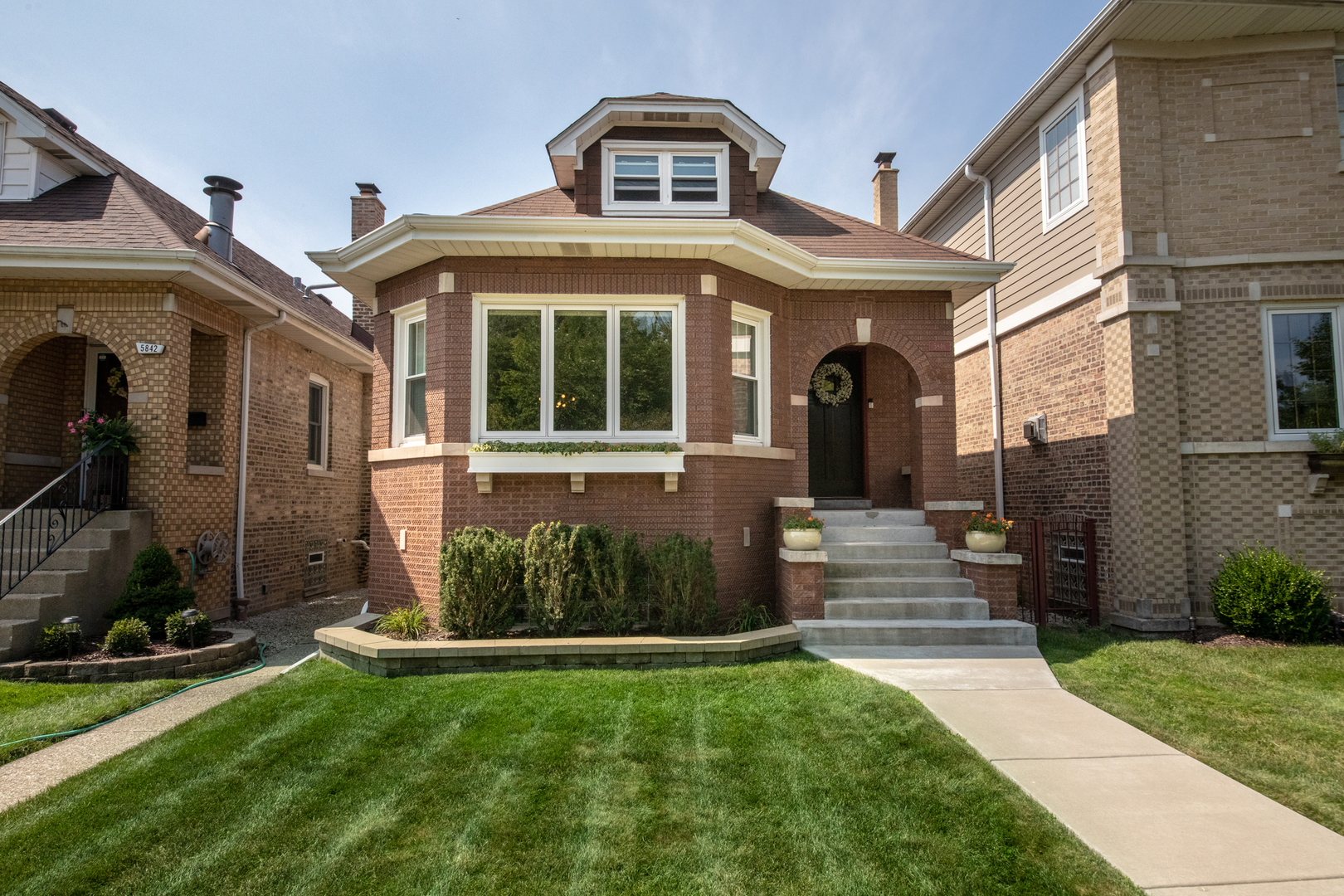 a front view of a house with garden