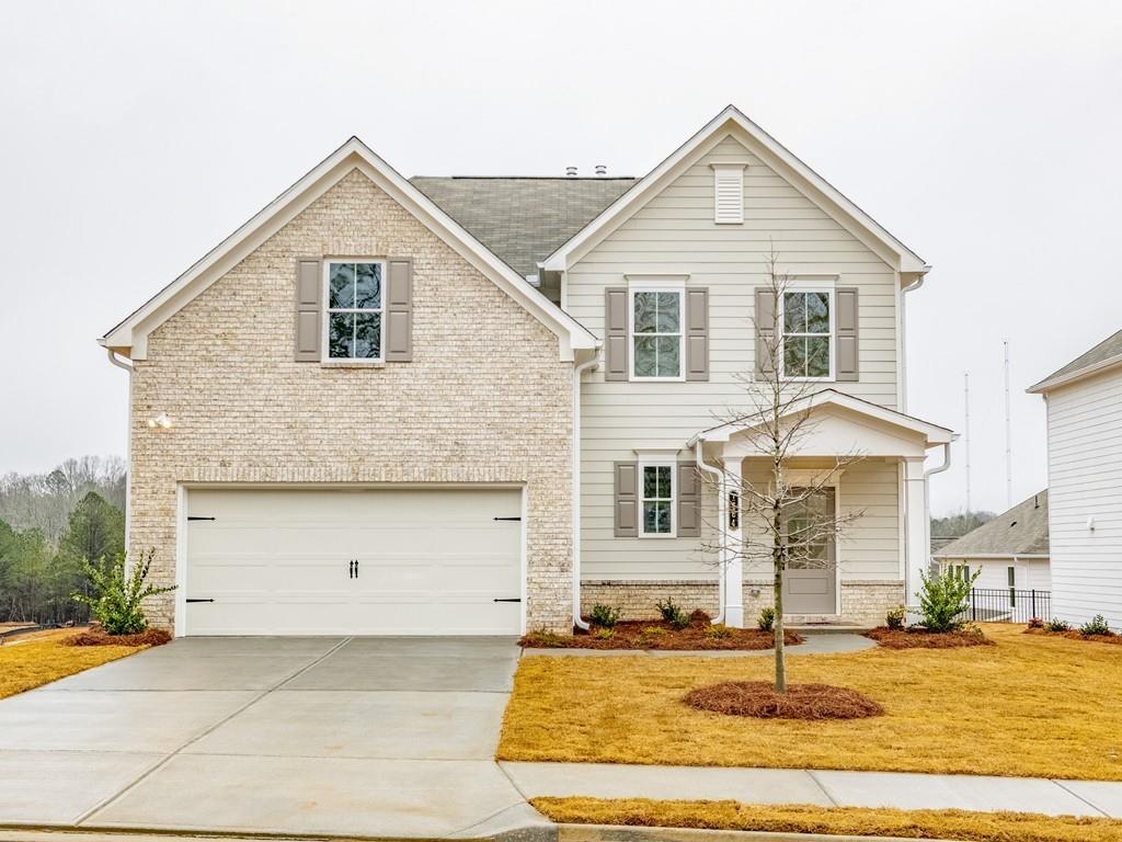 a front view of a house with a yard