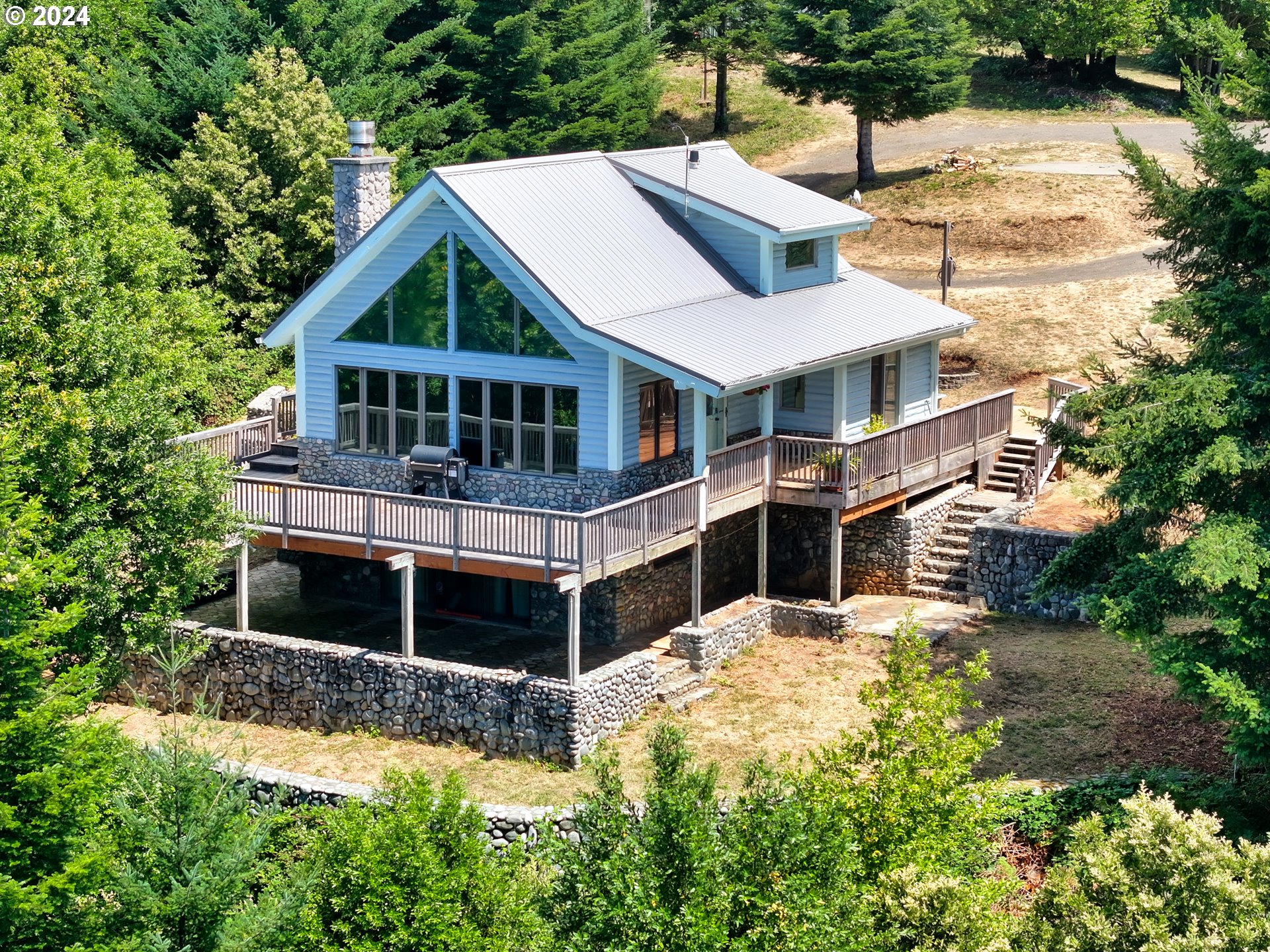 a view of house with yard and sitting area