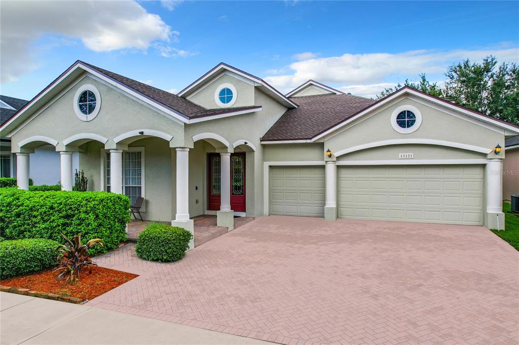 a front view of a house with a yard and garage