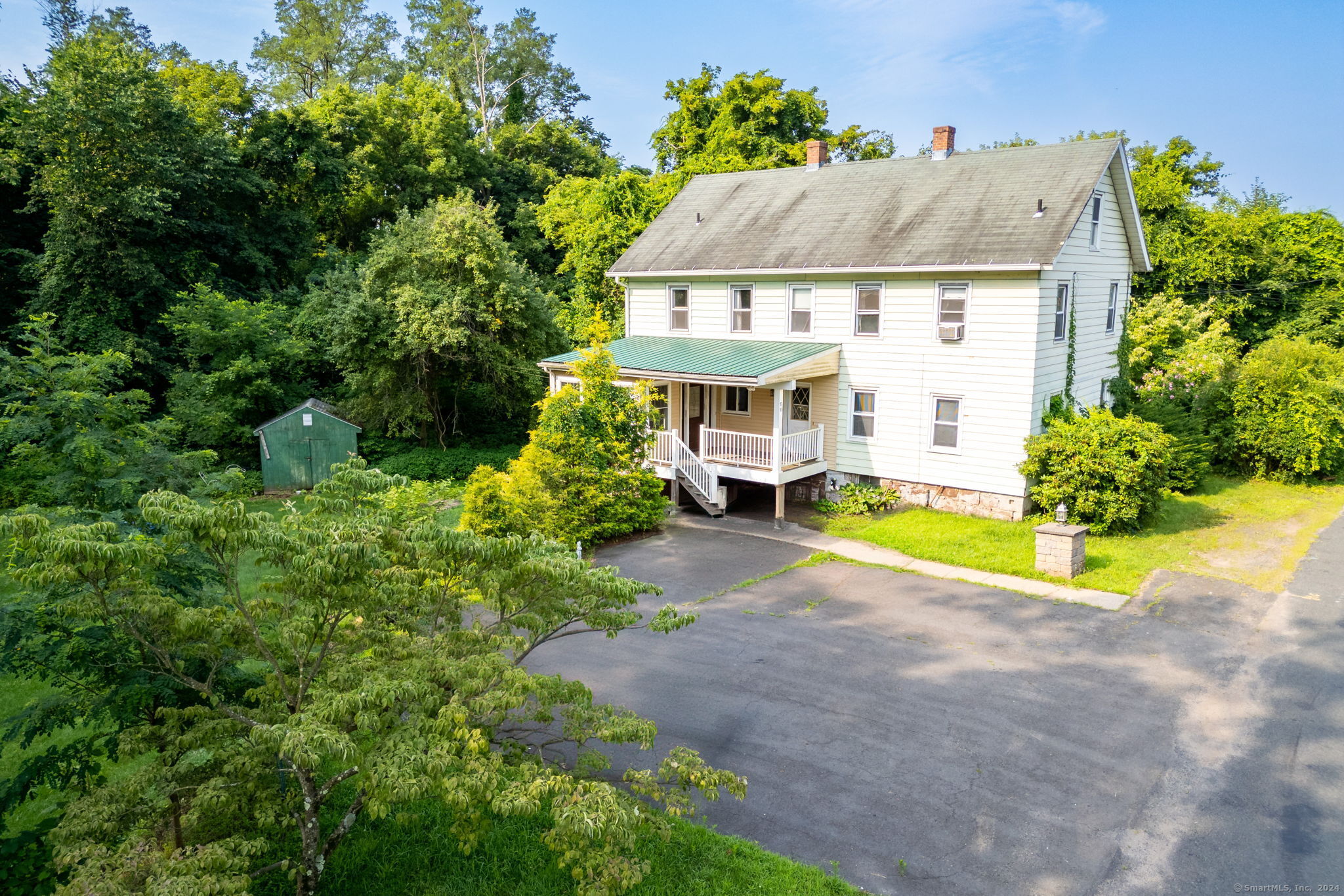 a view of house with garden and entertaining space