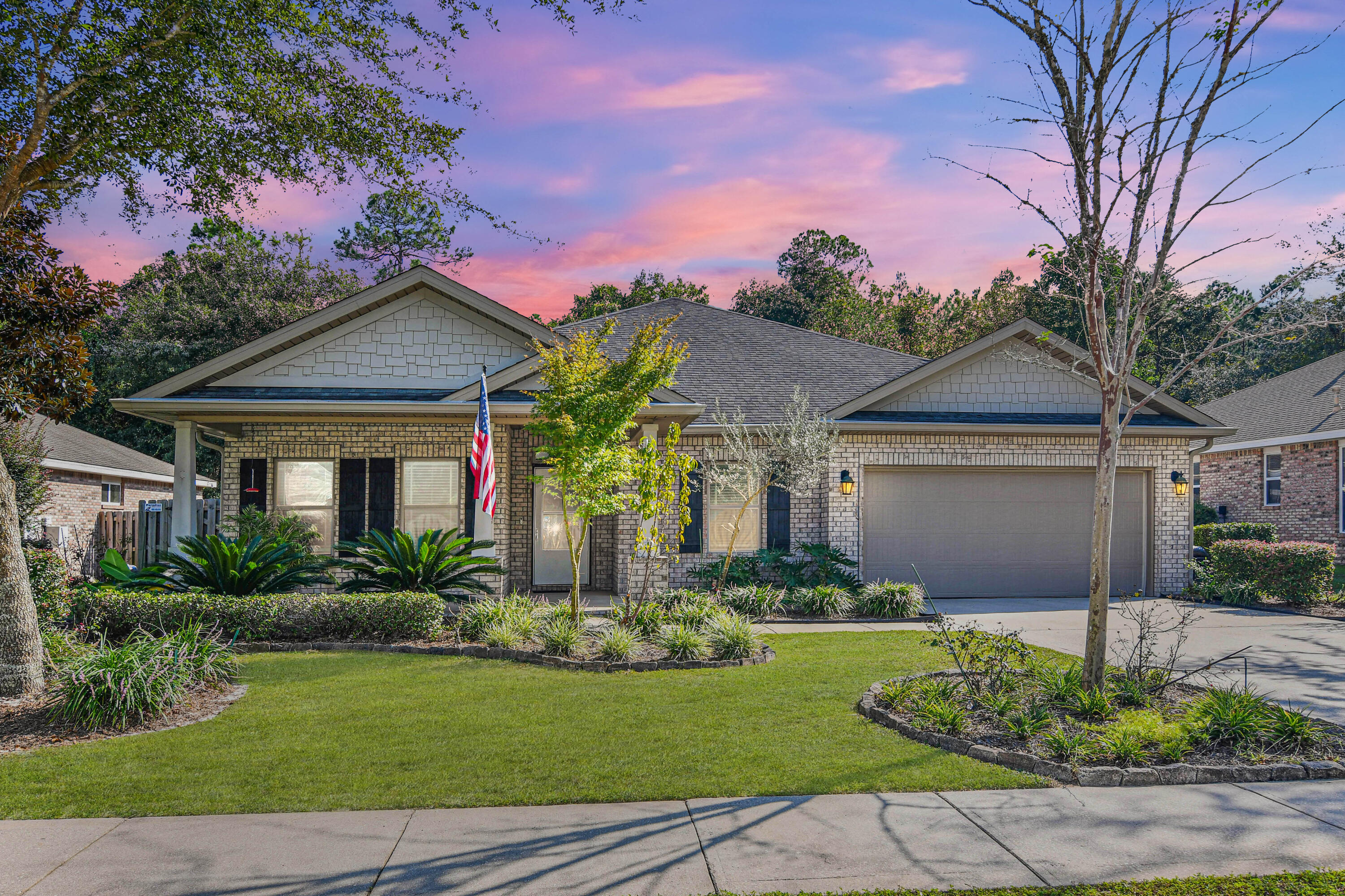 a front view of a house with a garden