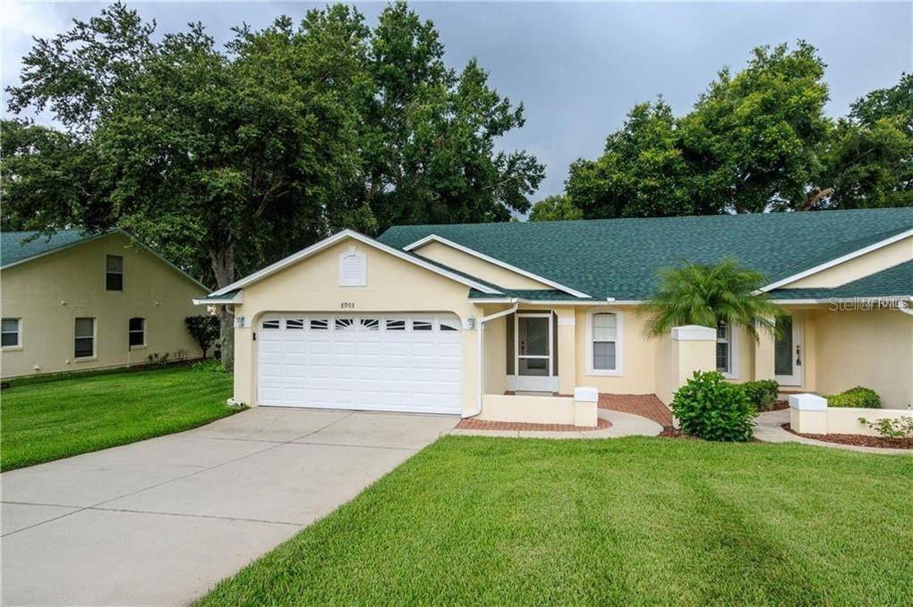 a view of a house with a yard and garage