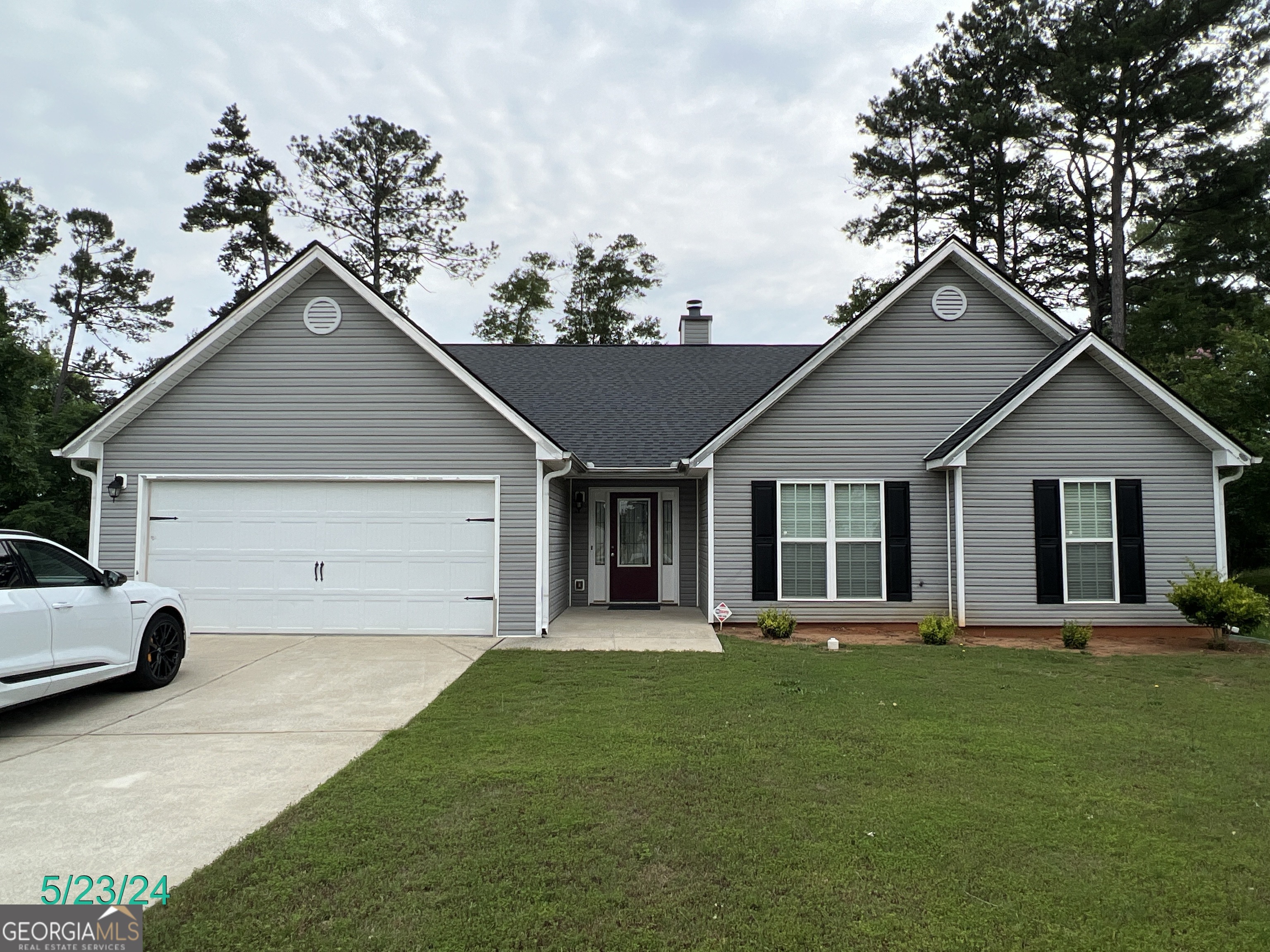 a front view of house with yard and green space